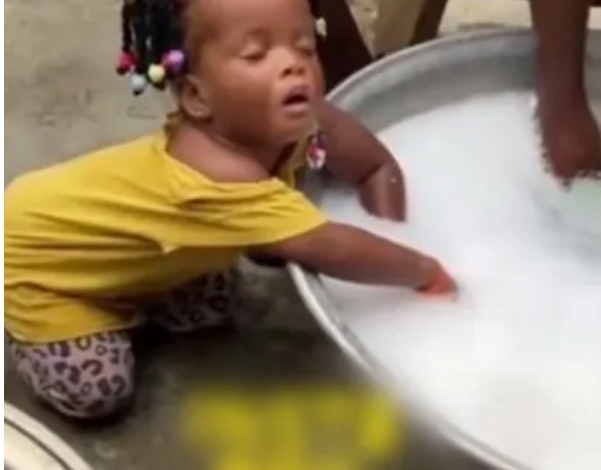 Cute little girl falls asleep while assisting mum to wash (Video)